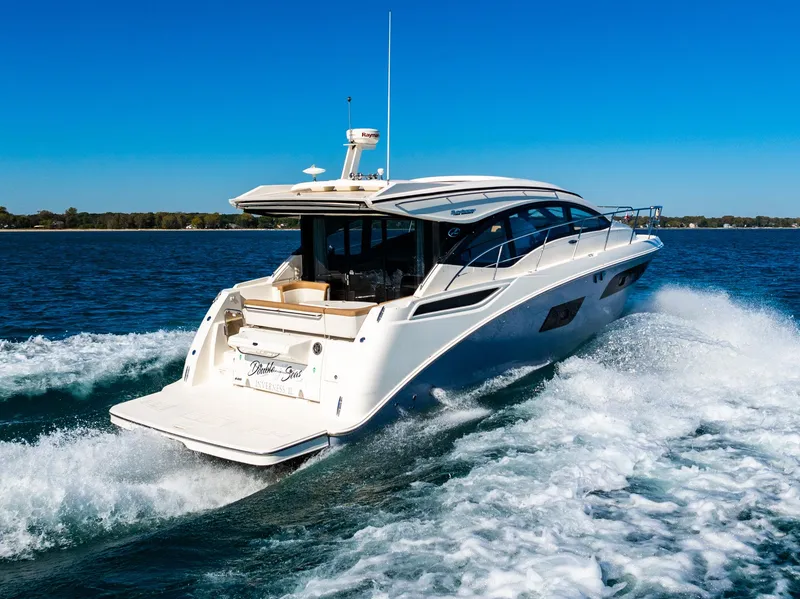 Slide: The Image of 2016 Sea Ray 400 Sundancer yacht cruising on open water. - 8