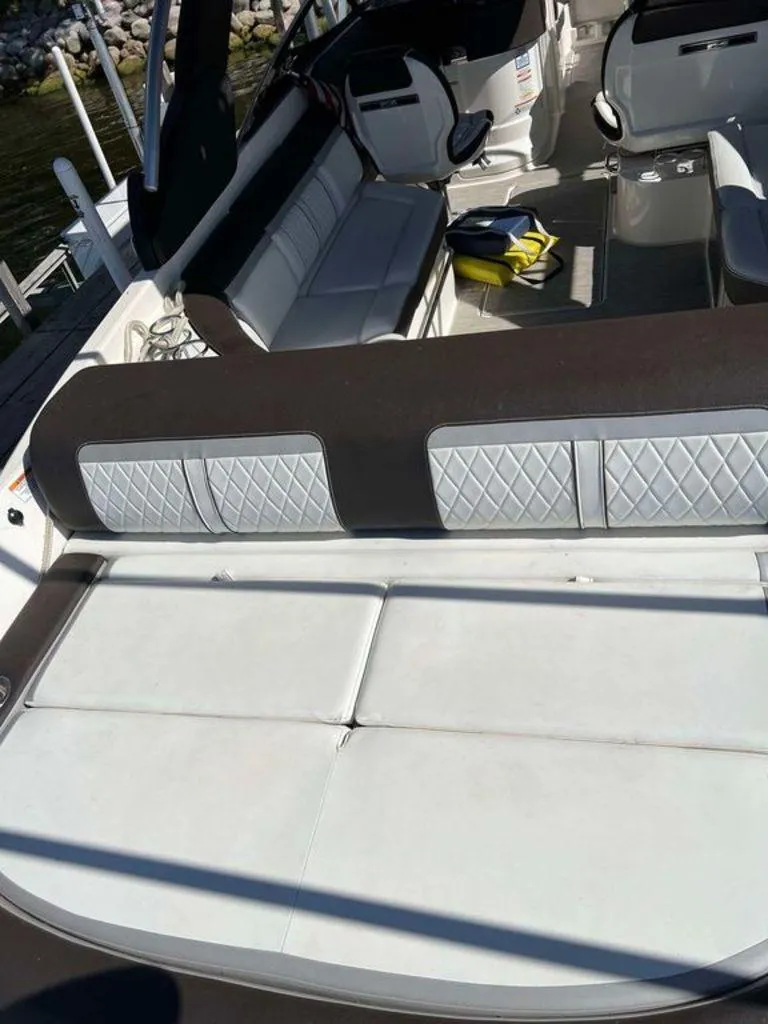 Slide: The Image of 2017 Sea Ray SLX 280 boat interior with white seating and modern design. - 10