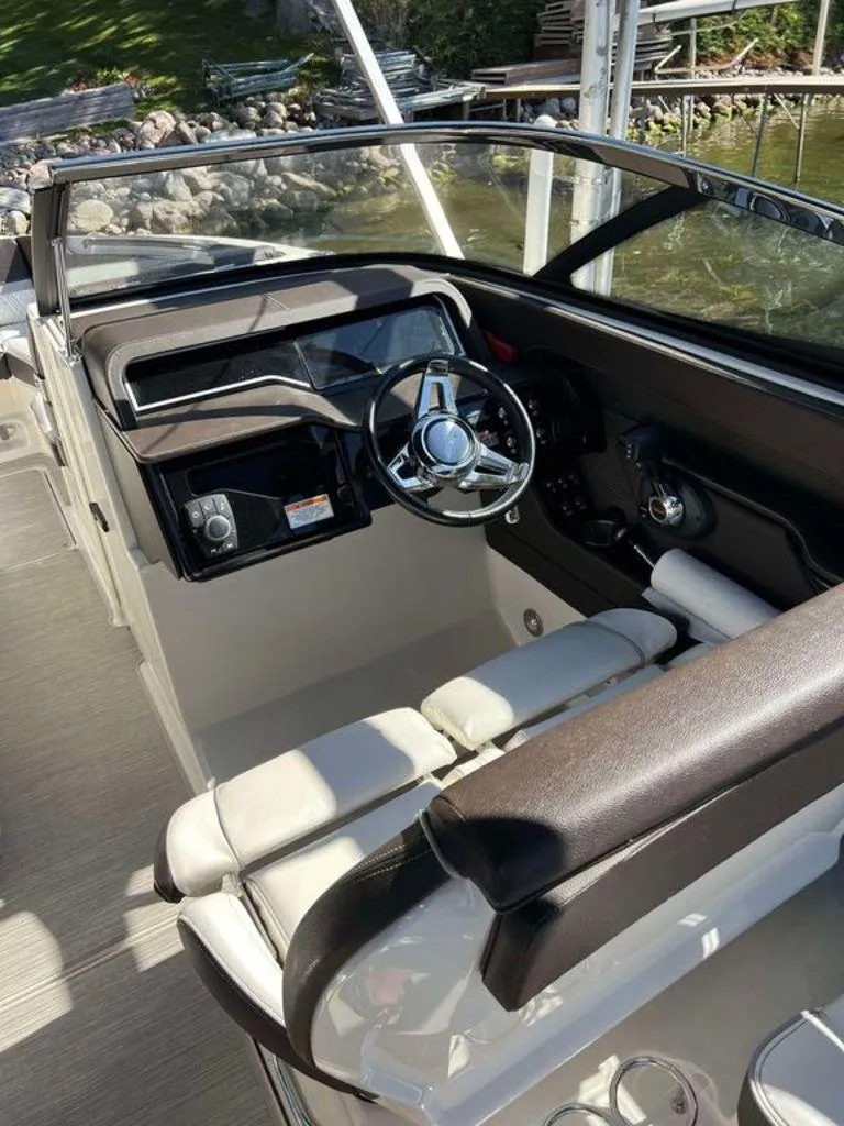 Slide: The Image of 2017 Sea Ray SLX 280 boat cockpit with steering wheel and seating. - 5