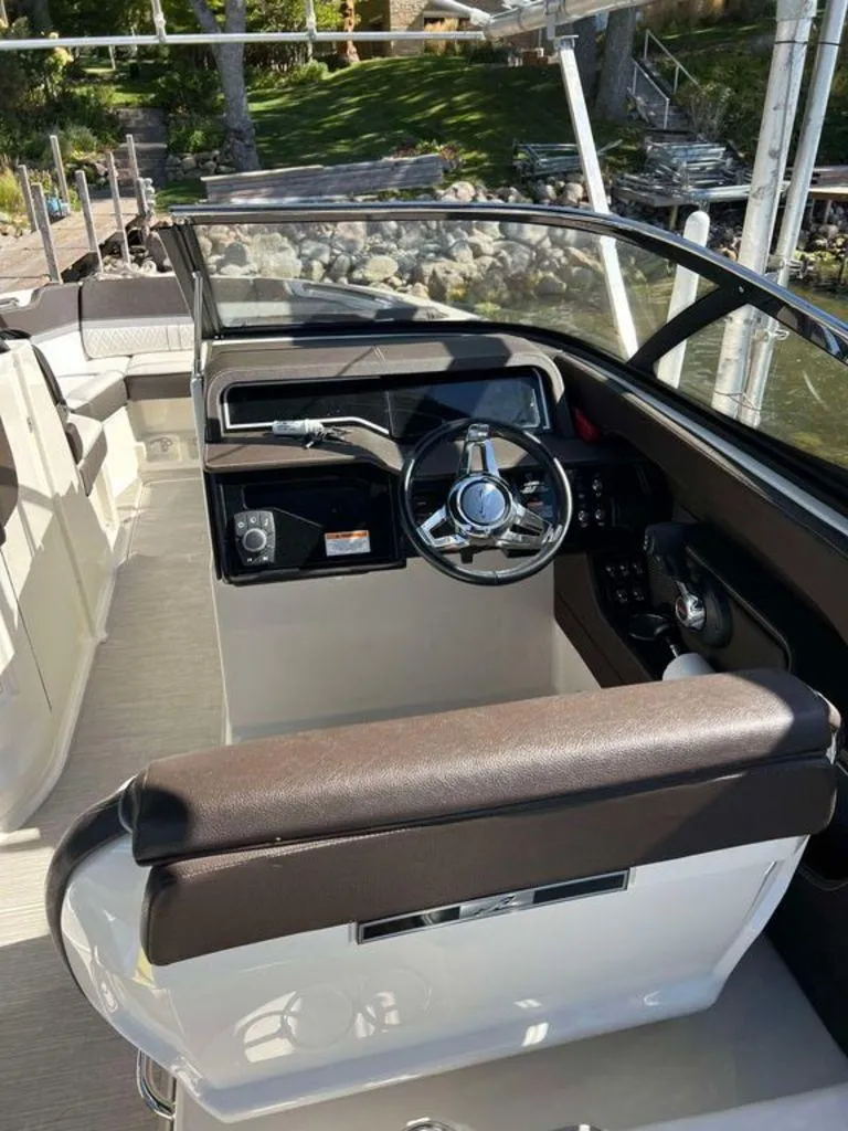 Slide: The Image of 2017 Sea Ray SLX 280 boat interior with steering wheel and seating. - 6