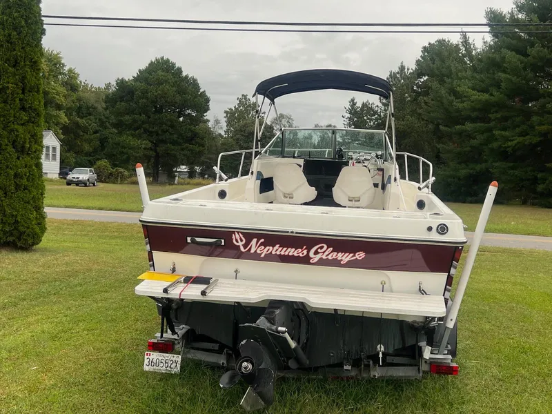 Slide: The Image of 1998 Seaswirl Striper 2150 Walkaround boat, "Neptune's Glory," parked on grass. - 2