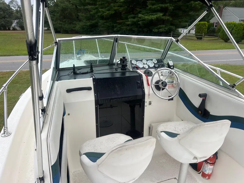 Slide: The Image of 1998 Seaswirl Striper 2150 Walkaround boat interior with steering wheel and seating. - 3