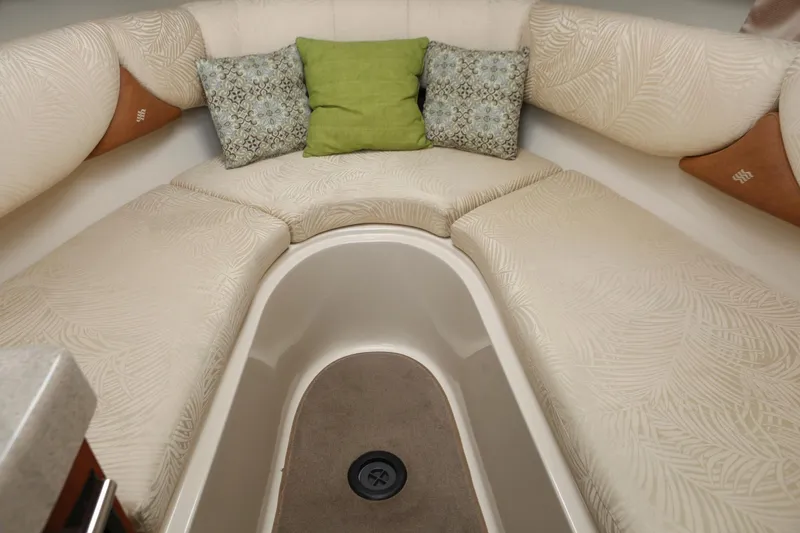 Slide: The Image of 2007 Four Winns 278 Vista cabin interior with beige seating and decorative cushions. - 11