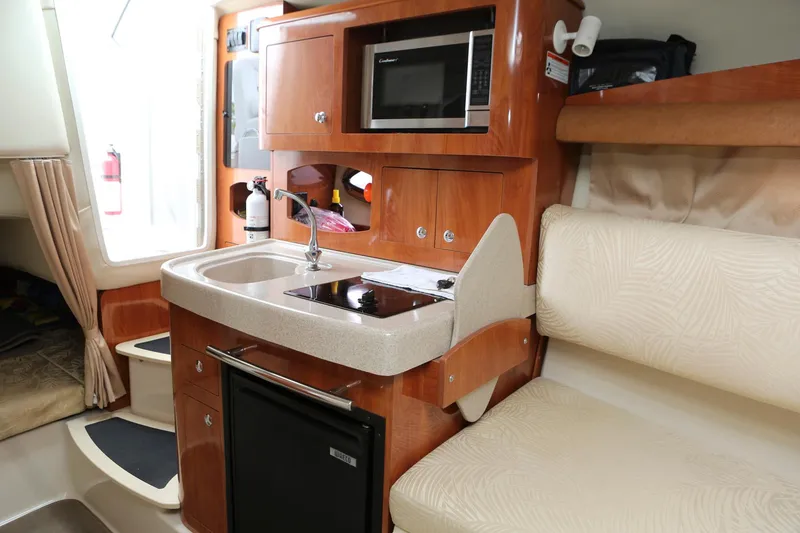 Slide: The Image of Interior of 2007 Four Winns 278 Vista boat with kitchenette and seating area. - 12