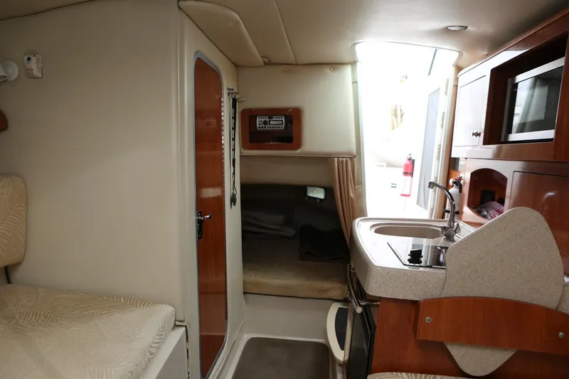 Slide: The Image of Interior of 2007 Four Winns 278 Vista boat with kitchenette and seating area. - 13