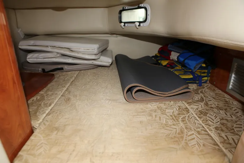 Slide: The Image of 2007 Four Winns 278 Vista cabin storage with cushions and rolled mats. - 14