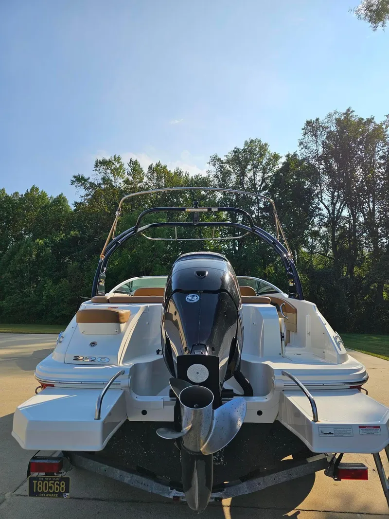 Slide: The Image of 2014 Sea Ray 220 Sundeck Outboard boat with powerful engine, parked outdoors. - 5