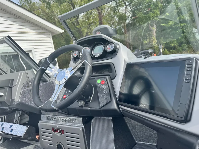 Slide: The Image of 2025 Ranger 621FS boat dashboard with steering wheel and Garmin display. - 5