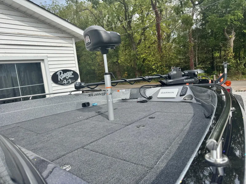 Slide: The Image of 2025 Ranger 621FS Ranger Cup Equipped boat with Garmin electronics, parked near a house. - 6