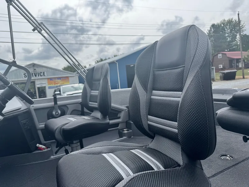 Slide: The Image of 2025 Ranger 621FS boat interior with black seats, overcast sky in background. - 9