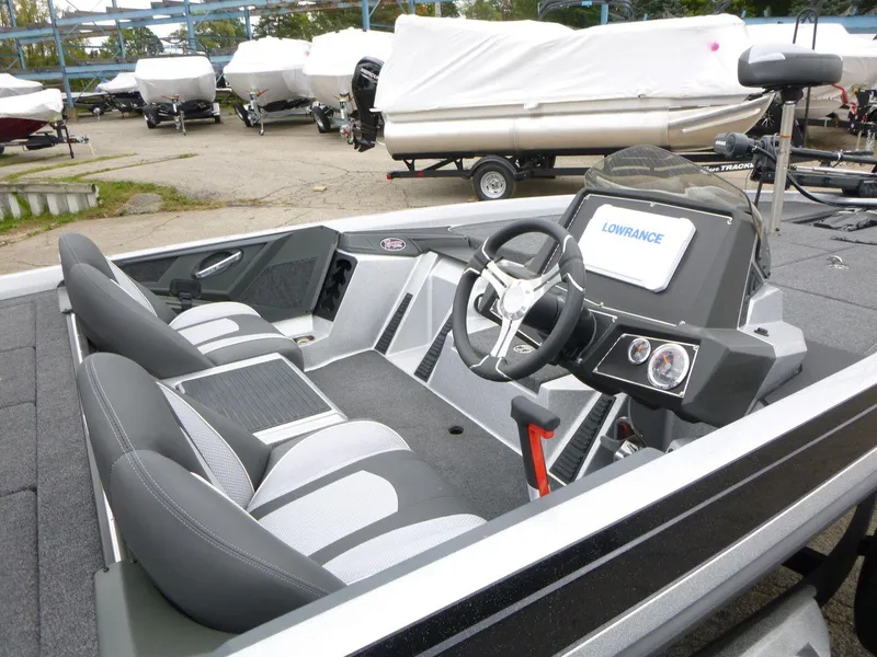 Slide: The Image of 2024 Ranger Z519 Ranger Cup boat interior with steering wheel and navigation system. - 11
