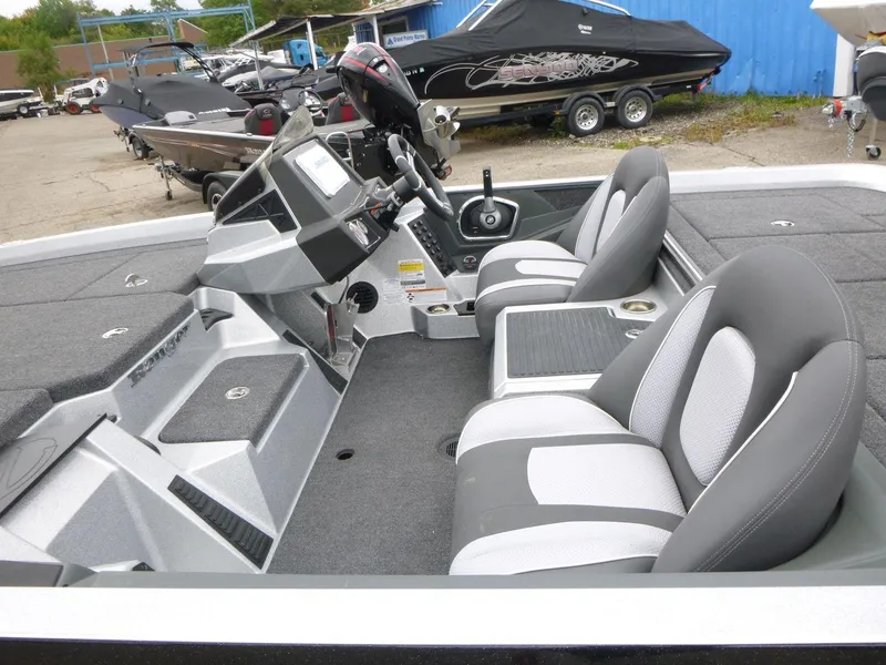 Slide: The Image of 2024 Ranger Z519 Ranger Cup boat interior with dual seats and control panel. - 8
