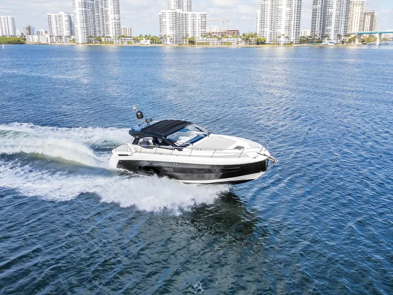 Slide: The Image of Azimut Atlantis 45 yacht cruising on water, 2020 model, city skyline in background. - 12
