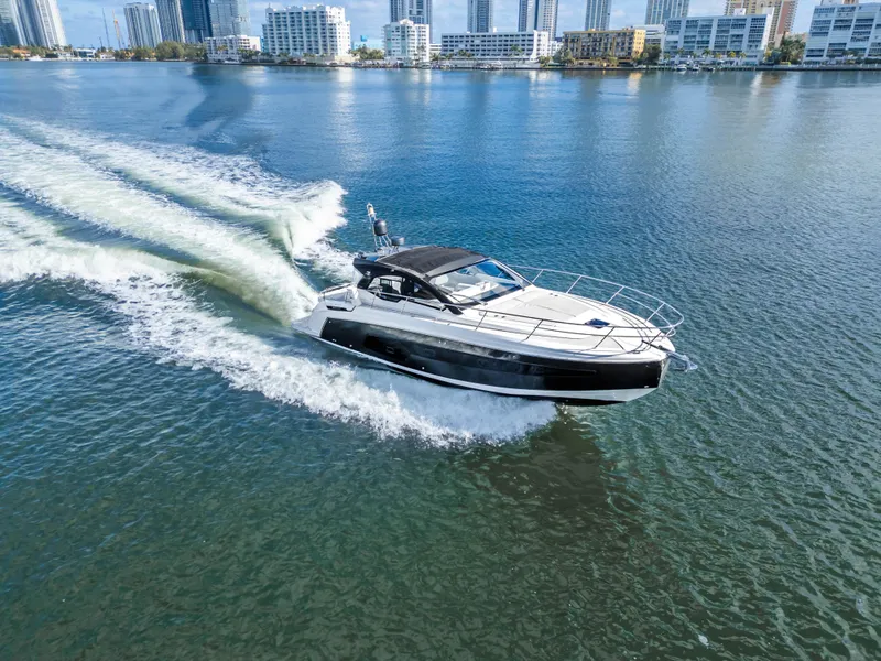 Slide: The Image of Azimut Atlantis 45 yacht cruising on water, city skyline in background, 2020 model. - 3