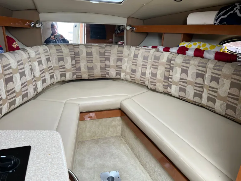 Slide: The Image of Interior of a 2007 Chaparral Signature 250 boat with beige seating and patterned cushions. - 11