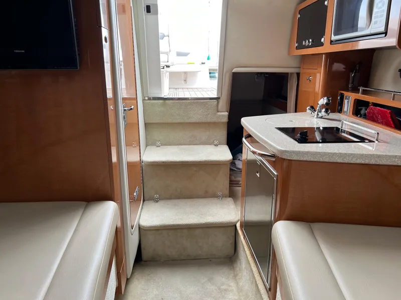 Slide: The Image of Interior of 2007 Chaparral Signature 250 boat with kitchenette and seating area. - 14