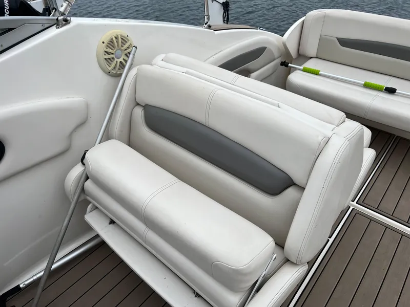 Slide: The Image of 2007 Chaparral Signature 250 boat interior with white leather seating and wood flooring. - 5