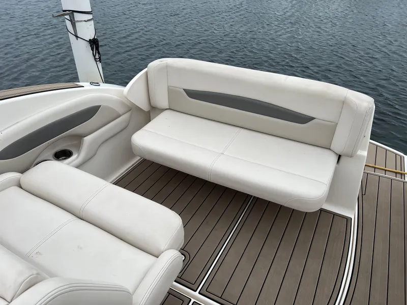 Slide: The Image of 2007 Chaparral Signature 250 boat interior with white seating and wood flooring. - 6