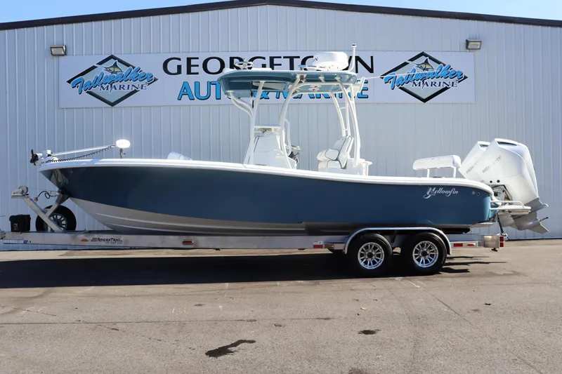 Slide: The Image of 2025 Yellowfin 26 Hybrid boat on trailer at dealership. - 0