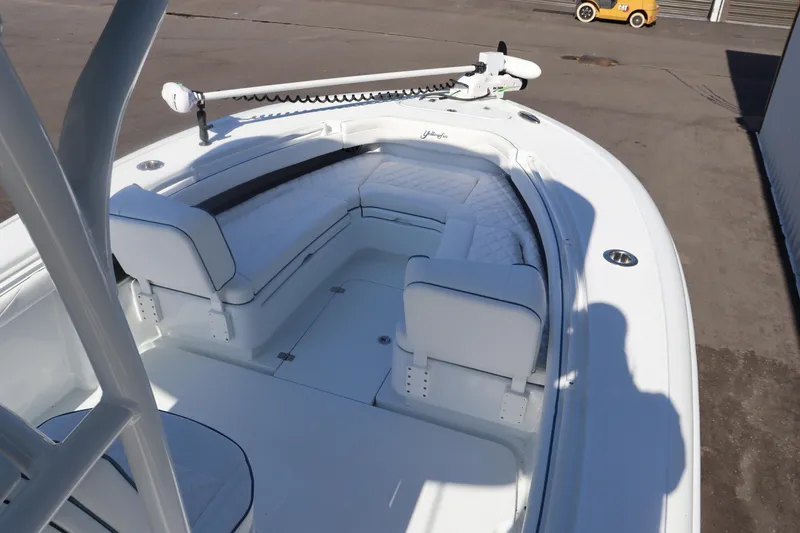 Slide: The Image of 2025 Yellowfin 26 Hybrid boat with white seating and trolling motor. - 15