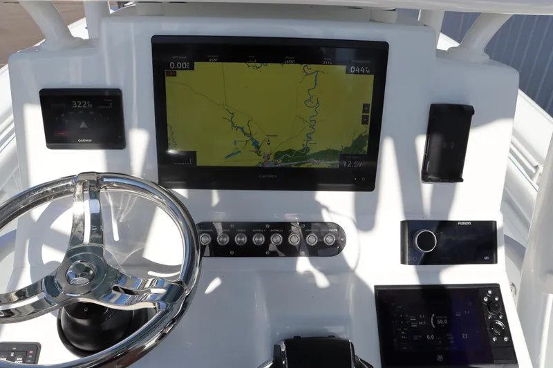 Slide: The Image of 2025 Yellowfin 26 Hybrid boat dashboard with navigation display and controls. - 16