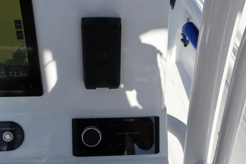 Slide: The Image of 2025 Yellowfin 26 Hybrid boat dashboard with electronic controls and display. - 19