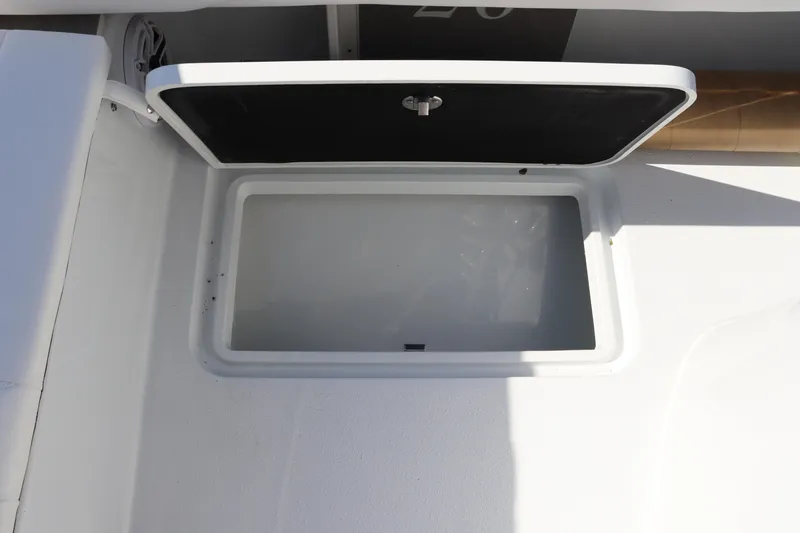 Slide: The Image of Open storage compartment on 2025 Yellowfin 26 Hybrid boat. - 27