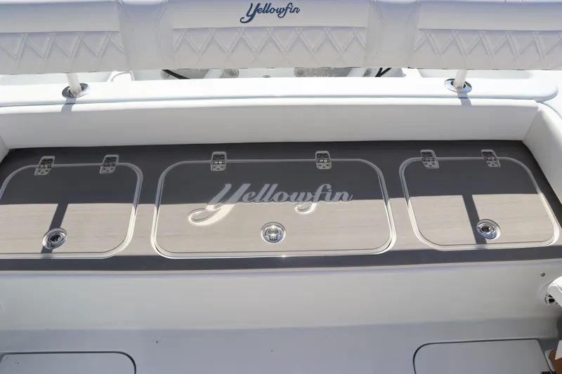 Slide: The Image of 2025 Yellowfin 26 Hybrid boat deck with storage compartments. - 29