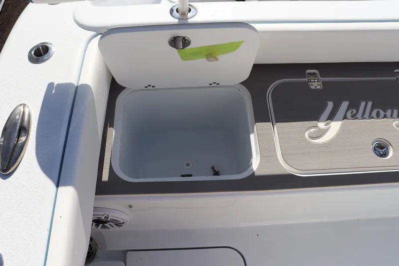 Slide: The Image of 2025 Yellowfin 26 Hybrid boat interior with storage compartment open. - 30