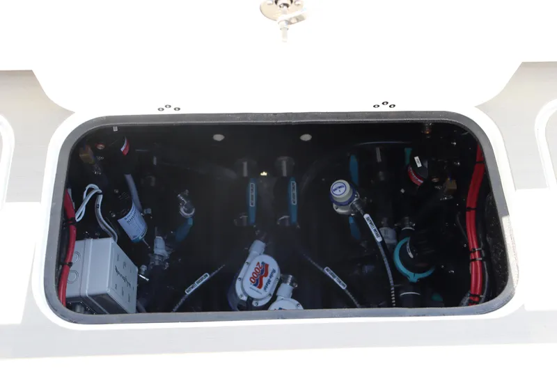 Slide: The Image of 2025 Yellowfin 26 Hybrid boat engine compartment with visible wiring and components. - 31