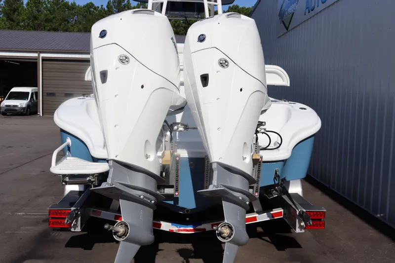 Slide: The Image of 2025 Yellowfin 26 Hybrid boat with dual outboard engines, parked on a trailer. - 4