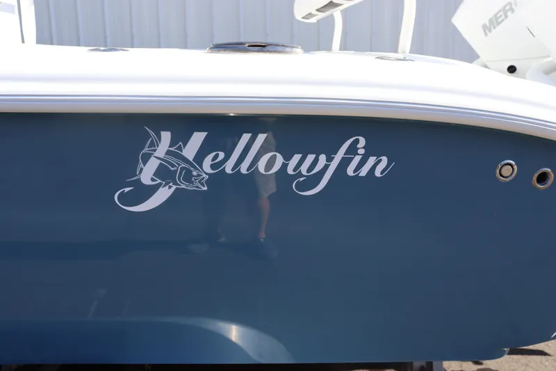Slide: The Image of 2025 Yellowfin 26 Hybrid boat with logo on blue hull. - 6