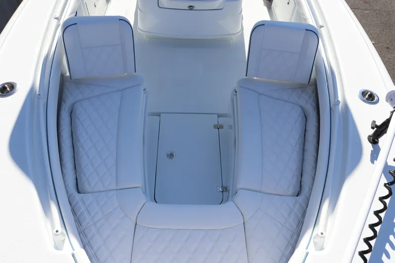 Slide: The Image of 2025 Yellowfin 26 Hybrid boat interior with white cushioned seating. - 7