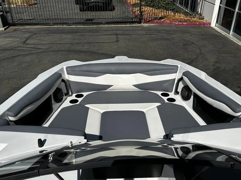 Slide: The Image of 2025 Axis A245 boat interior with gray and white seating, cup holders, and sleek design. - 6