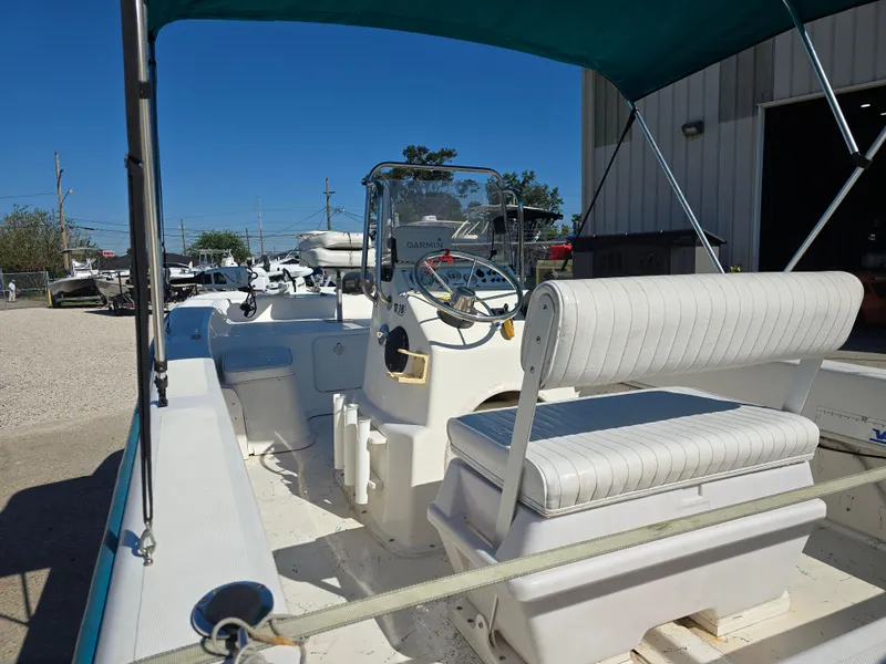 Slide: The Image of 2007 Sundance B18CC boat with seating and steering console, parked outdoors. - 10