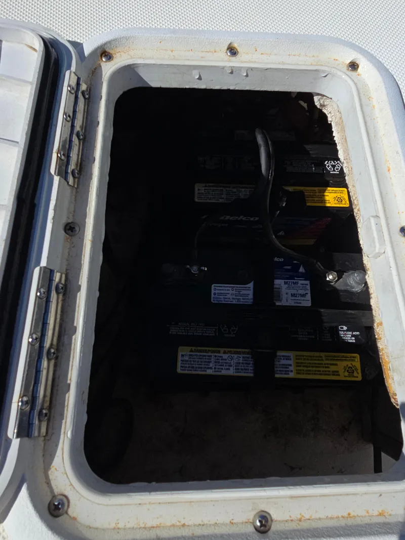 Slide: The Image of Boat battery compartment of 2007 Sundance B18CC, showing multiple batteries. - 11