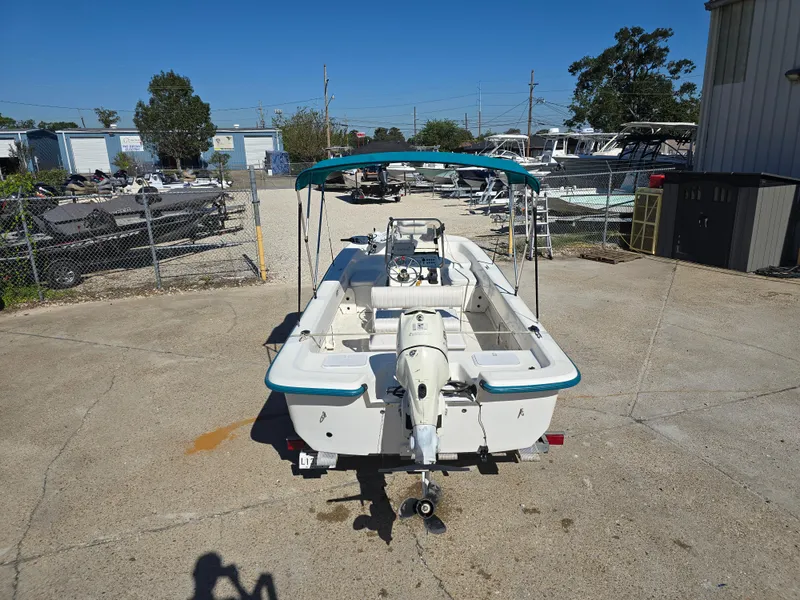 Slide: The Image of 2007 Sundance B18CC boat with canopy in a marina parking lot. - 3