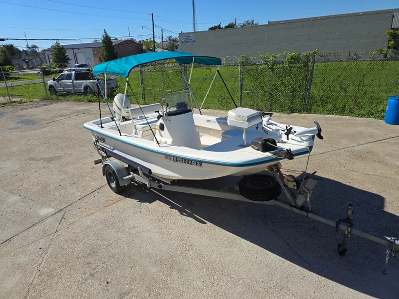 Slide: The Image of 2007 Sundance B18CC boat with canopy on trailer in parking lot. - 6