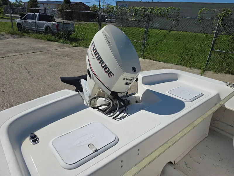 Slide: The Image of Sundance B18CC 2007 boat with Evinrude outboard motor in a sunny outdoor setting. - 8
