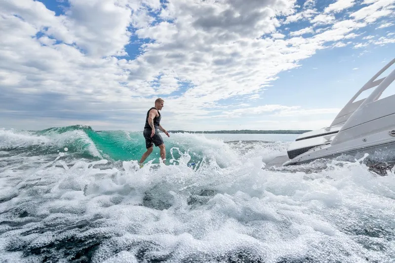 Slide: The Image of 2025 Regal LS2 Surf boat displayed indoors, showcasing sleek design and modern features. - 13