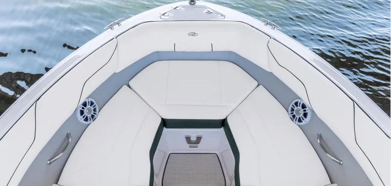 The Image of 2025 Regal LS2 Surf boat displayed indoors with digital brochure stand. - 2