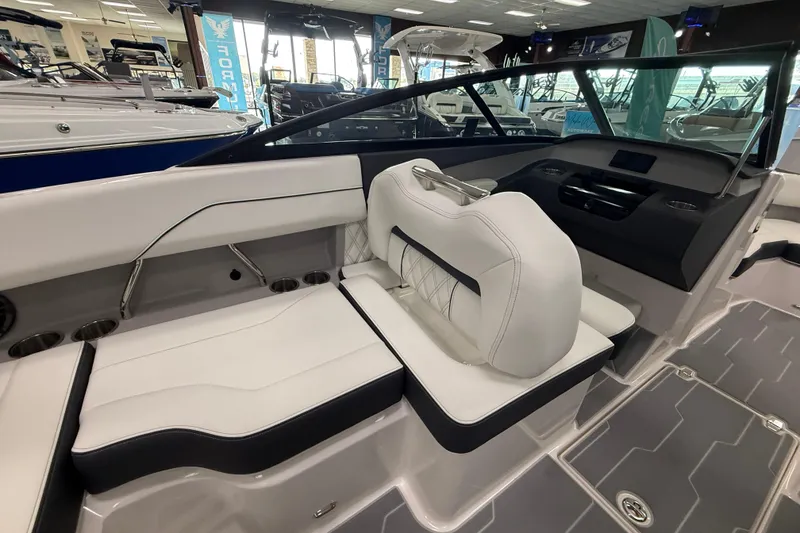 Slide: The Image of 2025 Regal LS2 Surf boat interior with white seating and modern dashboard design. - 36