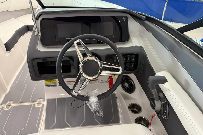 Slide: The Image of 2025 Regal LS2 Surf boat dashboard with steering wheel and control panel. - 38