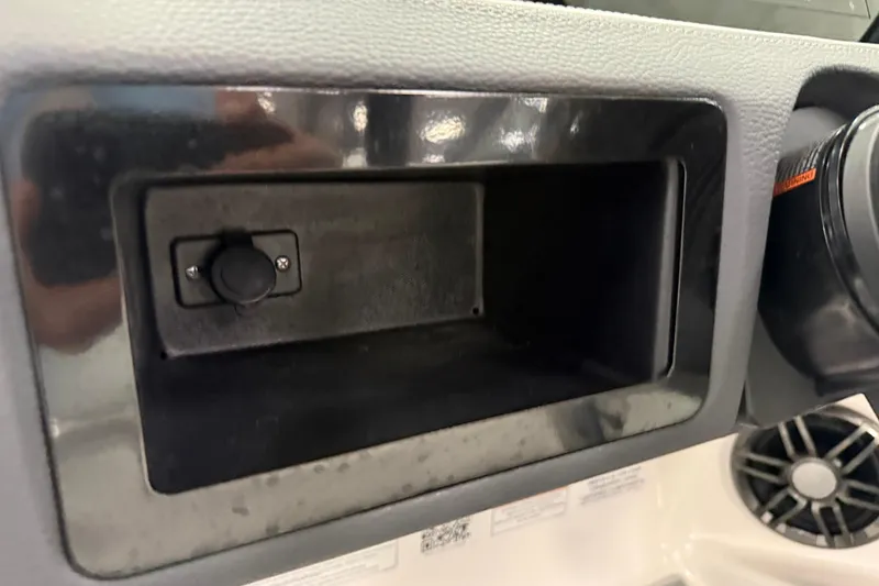 Slide: The Image of Dashboard compartment of 2025 Regal LS2 Surf boat with control button. - 39