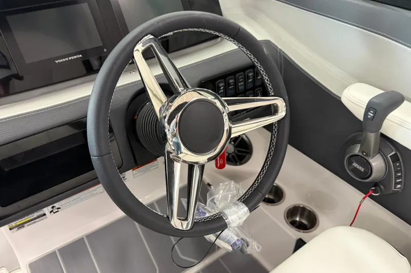 Slide: The Image of 2025 Regal LS2 Surf boat steering wheel and dashboard controls. - 41