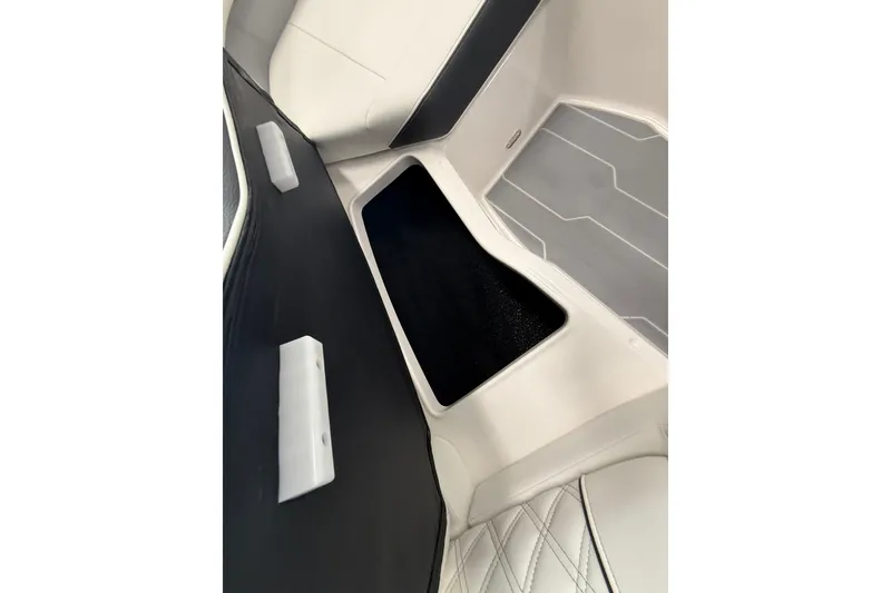 Slide: The Image of 2025 Regal LS2 Surf boat interior storage compartment with sleek design and modern upholstery. - 52