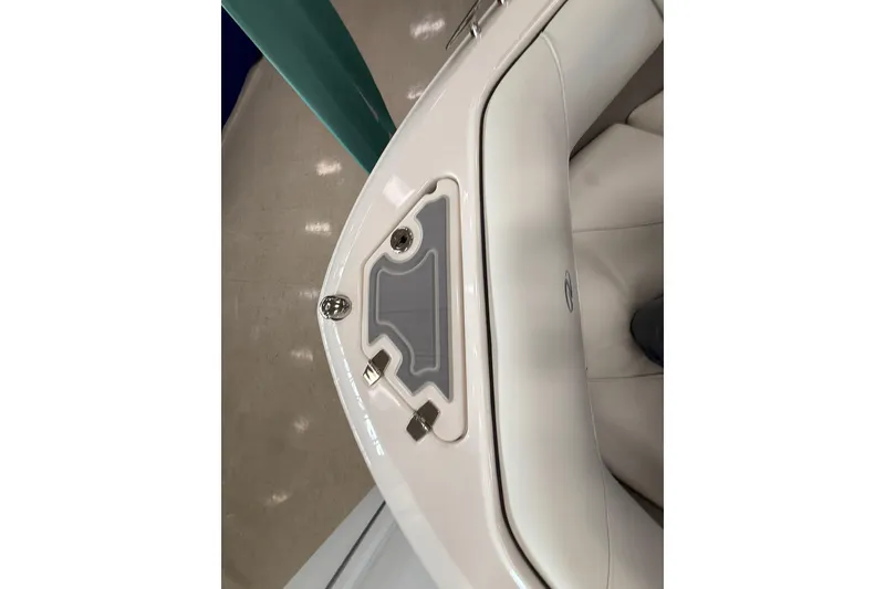 Slide: The Image of 2025 Regal LS2 Surf boat interior detail with sleek white seating and storage compartment. - 55