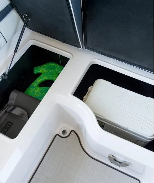 Slide: The Image of 2025 Regal LS2 Surf boat, sleek design with logo detail, indoor showroom display. - 9