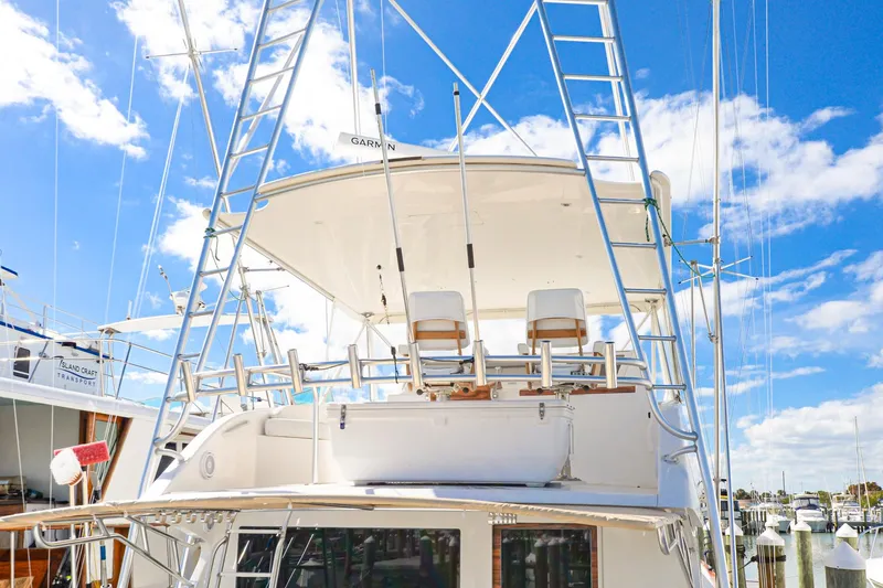Slide: The Image of 1999 Viking 55 Convertible yacht with flybridge, marina background, clear blue sky. - 10