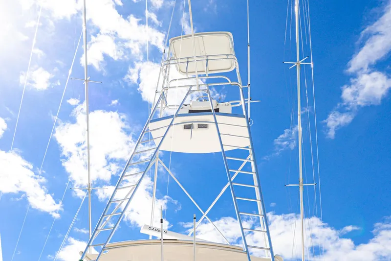Slide: The Image of Viking 55 Convertible 1999 yacht tower against a bright blue sky with clouds. - 11